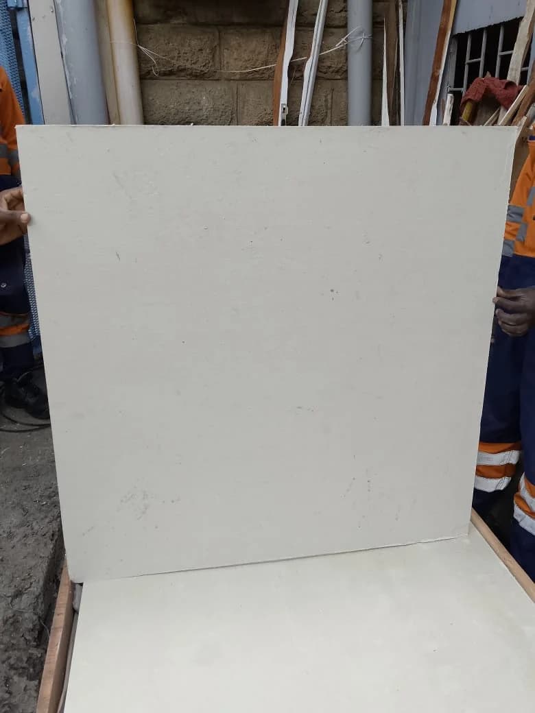 Large white asbestos millboard panel held upright