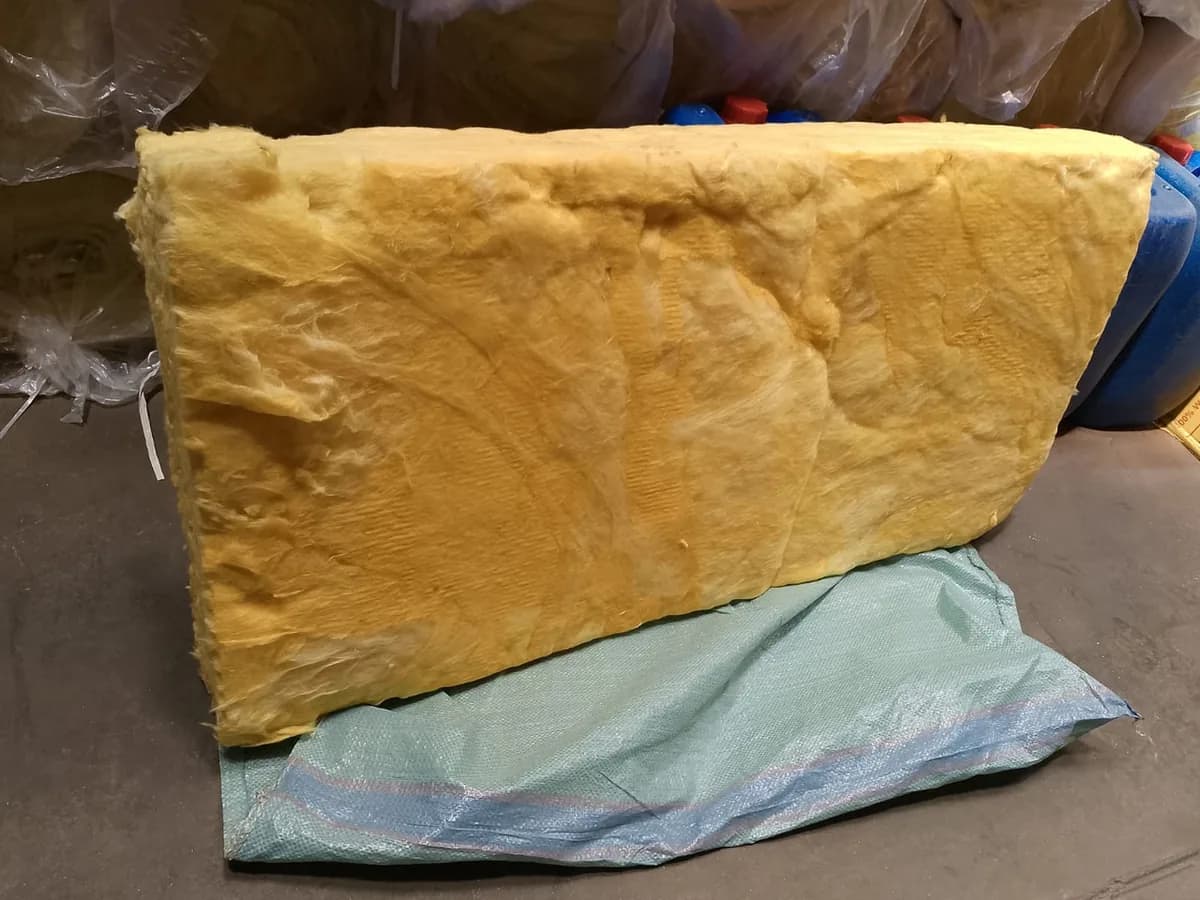 Yellow fiberglass glasswool insulation batt on a warehouse floor