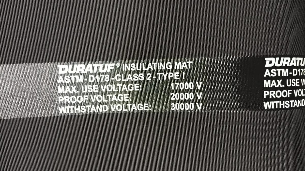Black high-voltage insulating rubber matting with printed class markings